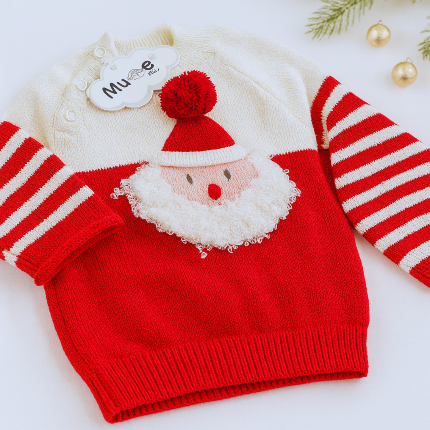 Red sweater with Santa Claus face design and matching striped socks on a white background